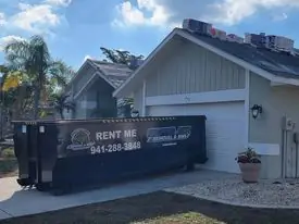 A Snapper roll-off in a house driveway